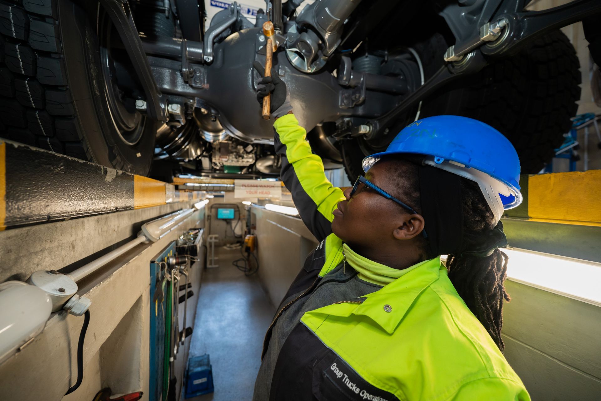 Worker inspecting a truck chassis at Volvo's Durban assembly plant.